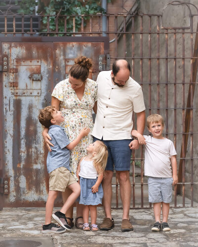 Precious family of 5 with 3 little kids in candid portrait in downtown mckinney