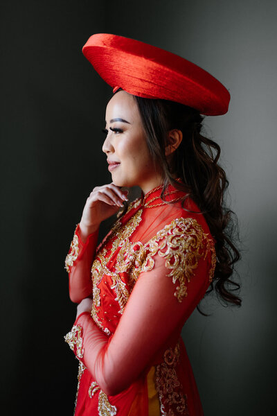 Beautiful Vietnamese bride in traditional red dress and hat shot by Calgary Vietnamese Wedding photographer