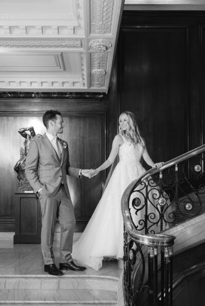 Elegant wedding portrait of bride and groom on staircase at the Union League Club of Chicago