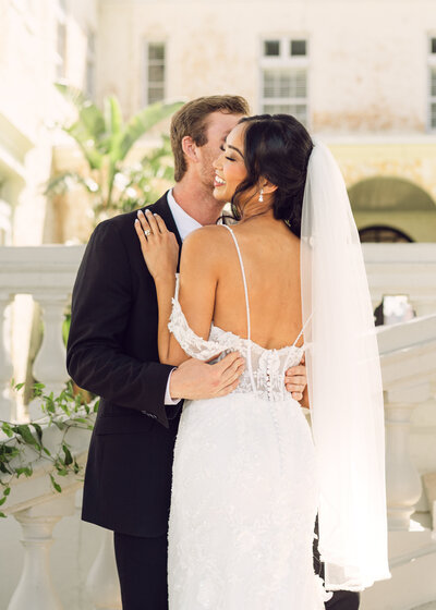 Groom kissing brides neck Bella Cosa Wedding Venue -Lake Whales-Florida