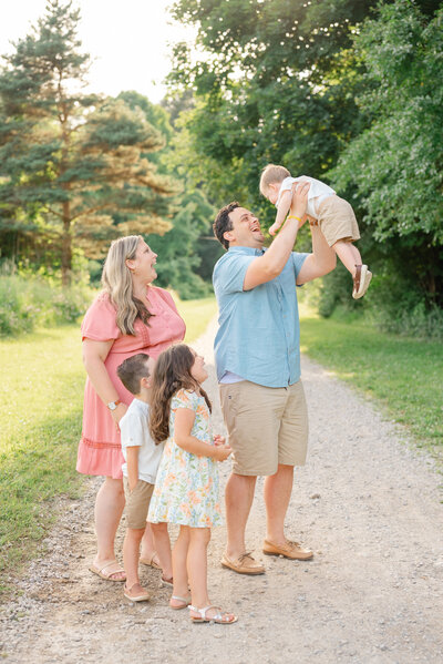 A family playing together outside during a family photo session. 