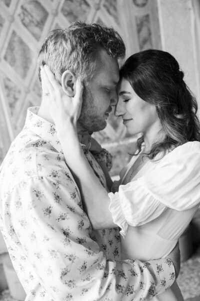 Intimate black-and-white portrait of an engaged couple embracing at Bethesda Terrace in Central Park, NYC, captured by wedding photographer Heritage House.