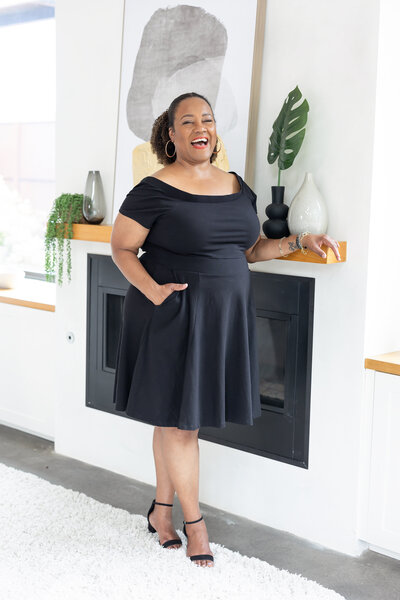Entrepreneur wearing a black dress posing for camera.