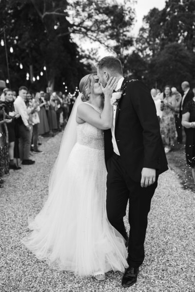 black & white of couple kissing at Pylewell Park on their wedding day