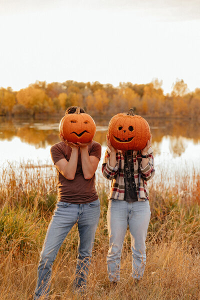 Unique engagement session with couple carving pumpkins