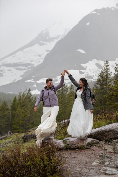 Bride & Groom looking like Vogue cover models while  sitting next to a lake in the  snowy  Sierra  Nevada mountains  of California.