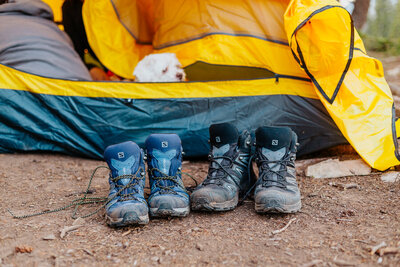 A pair of hiking boots sits outside a tent in Crested Butte, Colorado, showcasing the outdoor adventure spirit in the heart of the mountains.