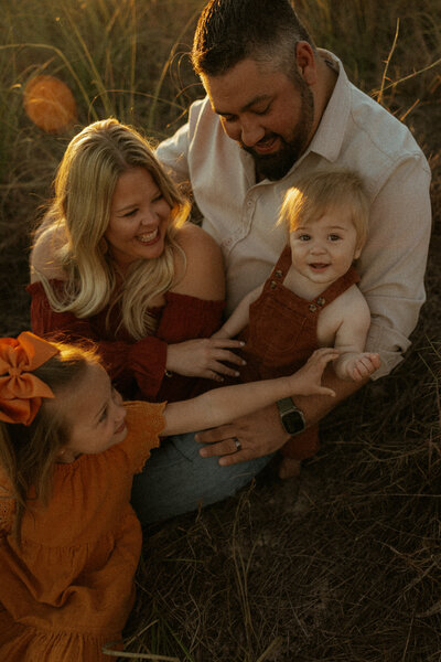 30a family sitting in dunes