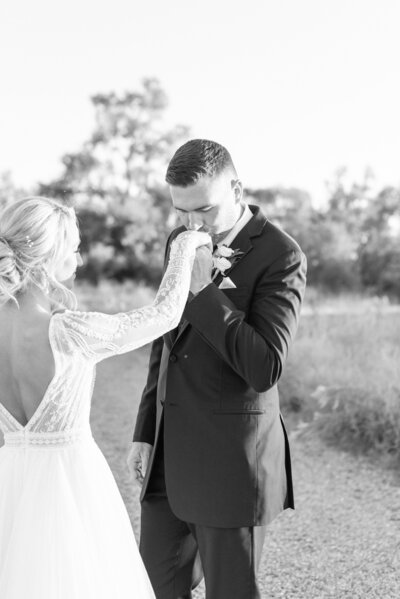 black and white image of groom kissing bride's hand by Courtney Rudicel wedding photographer in Indiana
