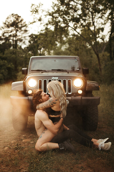 couple sitting in front of jeep