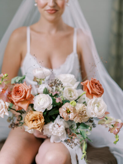 pastel neutral and white bridal bouquet with bride and veil