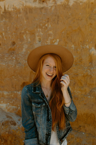 woman at providence canyon state park wearing a hat and smiling