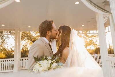 bride and groom share a kiss at wedding in arizona