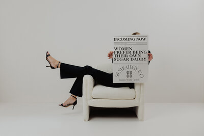 A women on the floor going through books and papers.