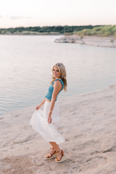 Malibu senior photos – stylish and sporty lakefront senior portraits with girl in white skirt and blue top
