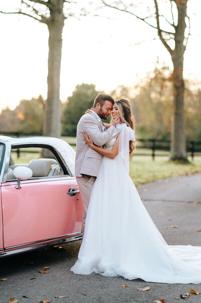 Bride and groom in front of a pink Figaro