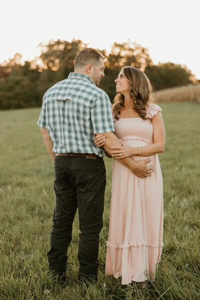 Expecting mother holding her baby bump for maternity pictures in Bucks County 