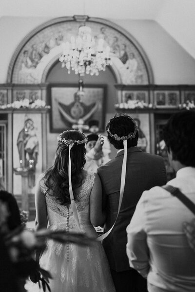 a bride and groom participating in a Catholic wedding