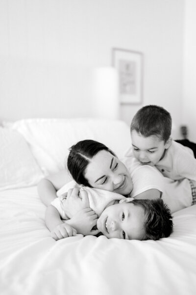 Black and white photo of sons and mother laughing