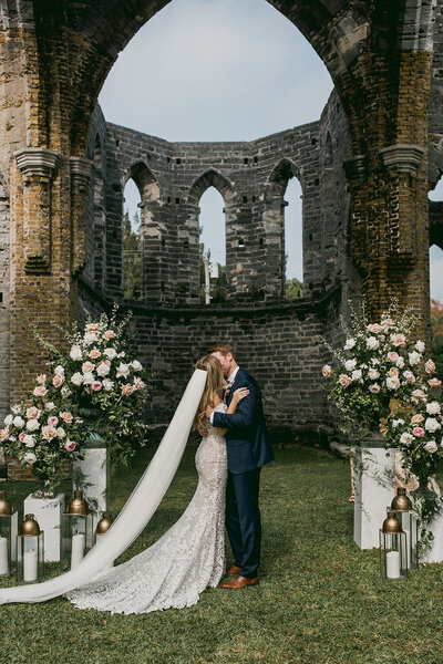 Bride and groom kissing at altar