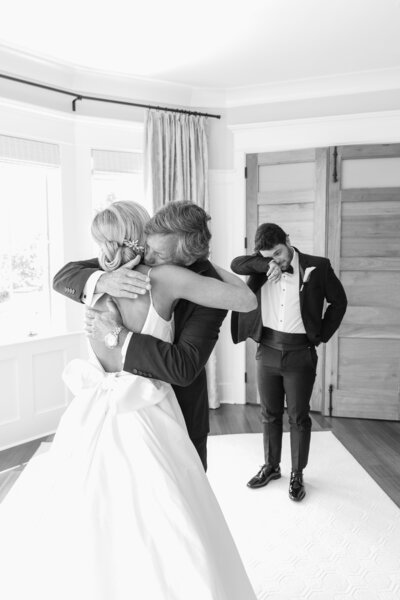 bride shares an emotional  first look with her dad and brother