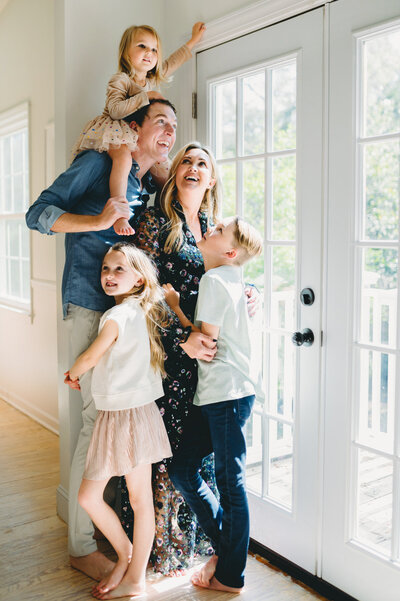 family of five hugging
