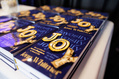 Joyosity book on table: guide for leaders for joy at work