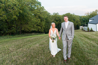 Wedding couple walking along forest at The Eloise