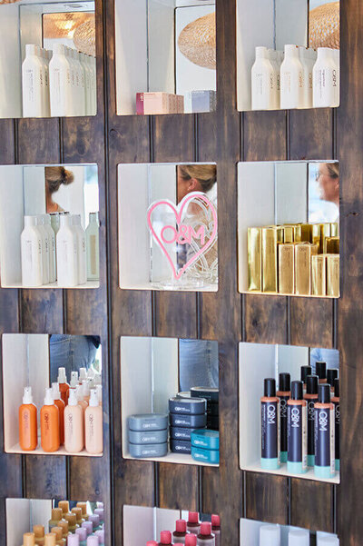 Copper-red hair styled in soft waves with a glossy finish, captured in a professional salon setting.