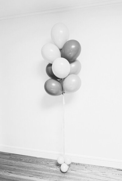 Black and white photo of weighted helium balloon decor