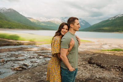 couple embracing at waters edge