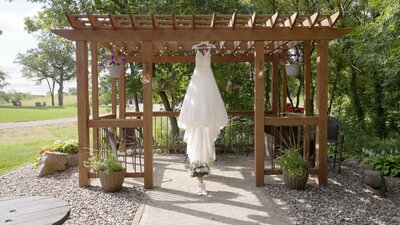 Bride's Gown Hanging outside for detail photos. Backyard Wedding  Wedding Videography in Webster, MN
