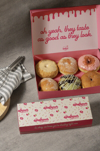 The Doughnut Experience brand identity, packaging, and logo design by Wildspark Creative. Female-led Michigan bakery branding combines boutique, feminine, and gourmet aesthetics with retail-ready visual impact for doughnuts and baked goods.

Michigan boutique bakery branding for The Doughnut Experience. Wildspark Creative designed logo, packaging, and brand identity to highlight gourmet doughnuts, feminine aesthetics, and cohesive, retail-ready presentation for female founders.