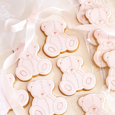 Decorated teddy bear biscuits sugar cookies for a baby shower  with pink details and ribbon