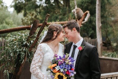 Couple with a bright bouquet getting married with the koalas at Healesville Sanctuary