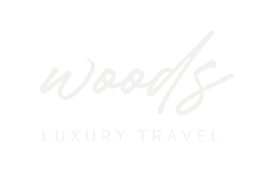 Test based logo, "Woods" in a script font with "Luxury Travel" in  a sans serif font.