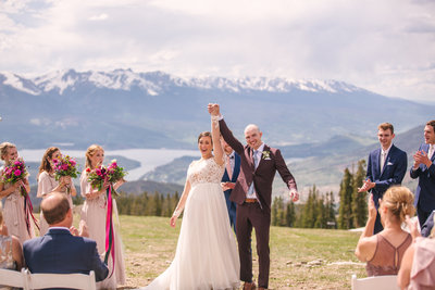 Bride and groom celebrate after saying their vows at the summit in Keystone Colorado