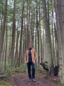 Photo of Tony Asgari standing in the woods
