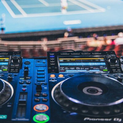 Event DJ performing live at the United Cup tennis tournament for fan entertainment and hospitality