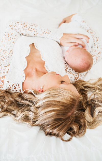 San Diego Newborn Photography, mother laying in bed with newborn baby