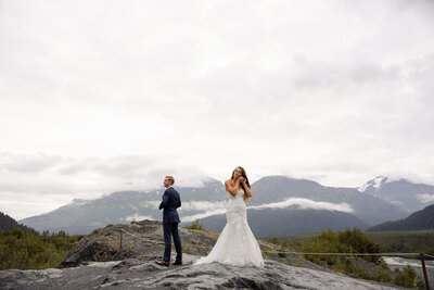 Bride putting her earrings in for their adventure hike during their elopement