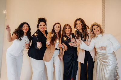 The team at Capital Realty Group, Fathom Realty posing with Sparklers