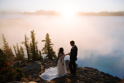 photo of couple kissingin front of helicopter that was part of their Banff elopement package