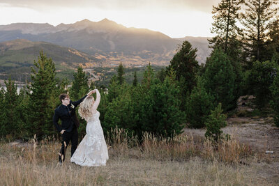 colorado elopement planning guide - groom twirls bride during colorado elopement in the mountains