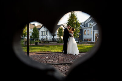 A creative portrait of a couple framed with heart  on their wedding day.