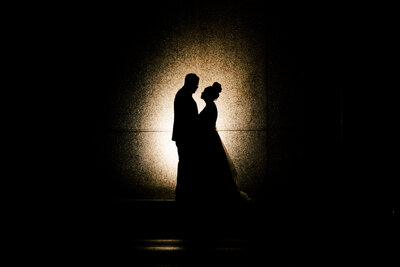 Luxury Portraits by Moving Mountains Photography in NC - Silhouette photo of a bride and groom.