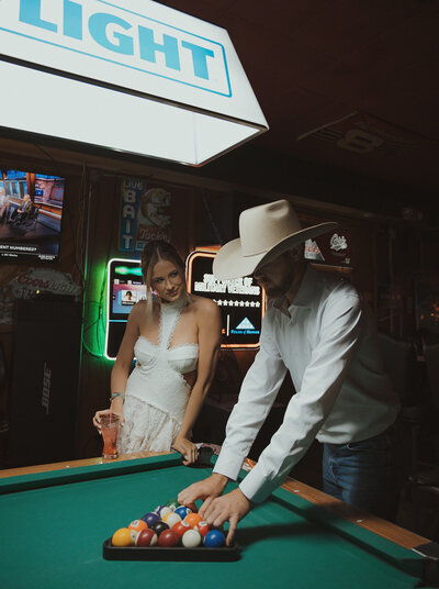 Georgia engagement photos in bar couple playing pool