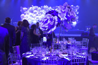 Purple-toned stage and lighting at a Times Square fundraising gala at Marriott Marquis
