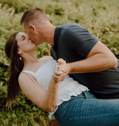 Maryland couple kissing in front of greenery