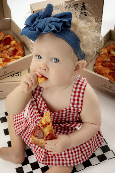 Close up of girl biting a piece of pizza